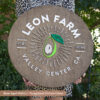 custom round farm logo wood sign with aged walnut base and custom color laser cut logo lettering