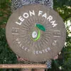 custom round farm logo wood sign with aged walnut base and custom color laser cut logo lettering
