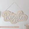 Girl's personalized first name sign with natural wood base with white lettering