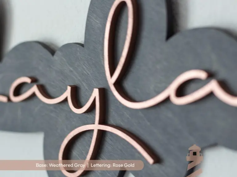 Elegant girl's laser cut wood bedroom nursery sign with grey base and rose gold lettering. Custom first name sign.