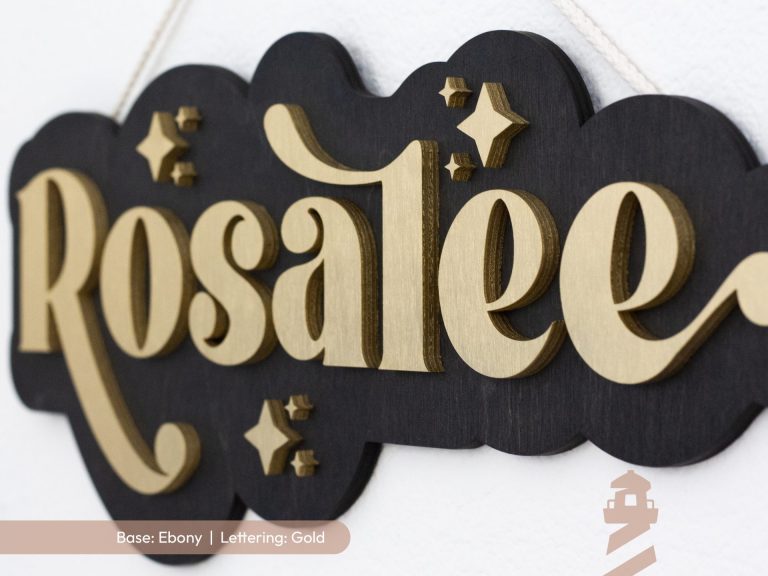 Girl's bedroom sign with ebony base and gold lettering. Custom made for girl's first name out of laser cut wood.