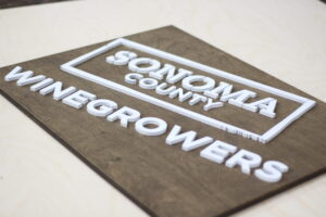 custom winegrowers, winery, cellar sign with aged walnut base and white logo 3D lettering