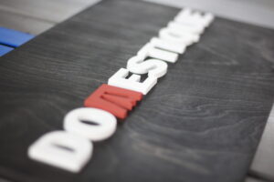 personalized custom business sign with two logo colors and a black ebony base on wood