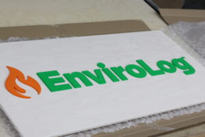 Business logo sign with a white wash base and color logo