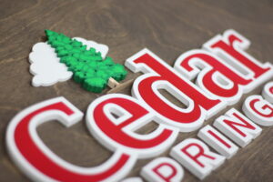 bespoke hand-painted logo business sign on a walnut base