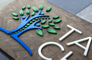 chiropractic sign with personalized tree and leaves logo with multiple colors
