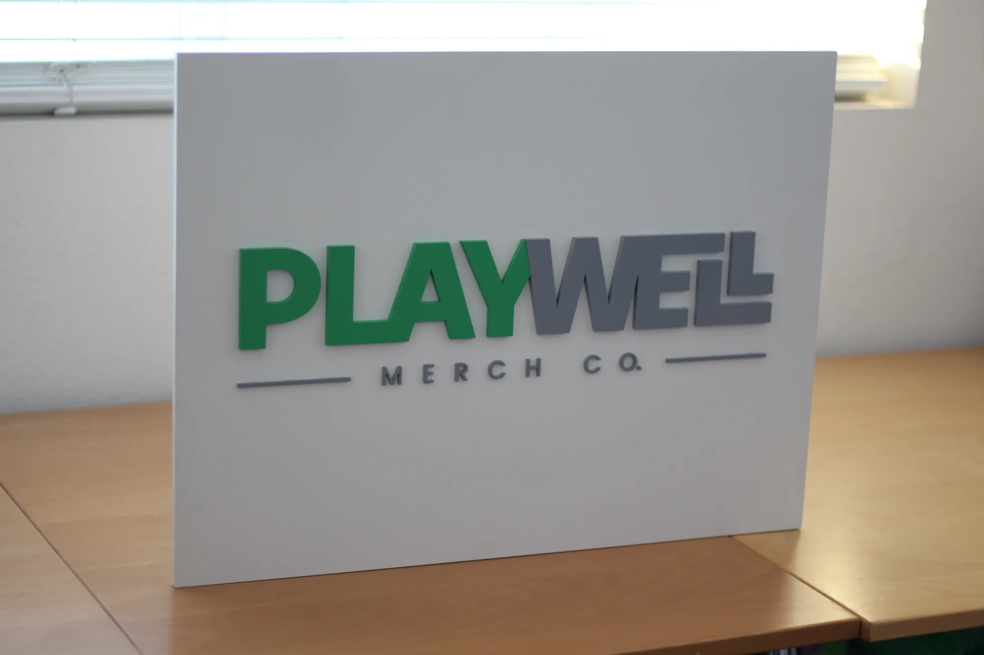 Apparel brand wood logo sign shown in context