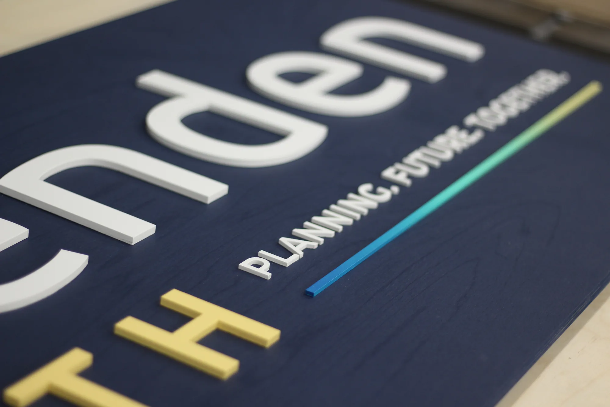 Detail of the multi color logo on navy