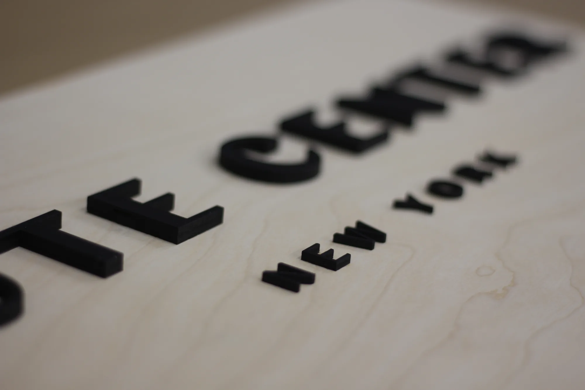 Detail of the black lettering on natural birch