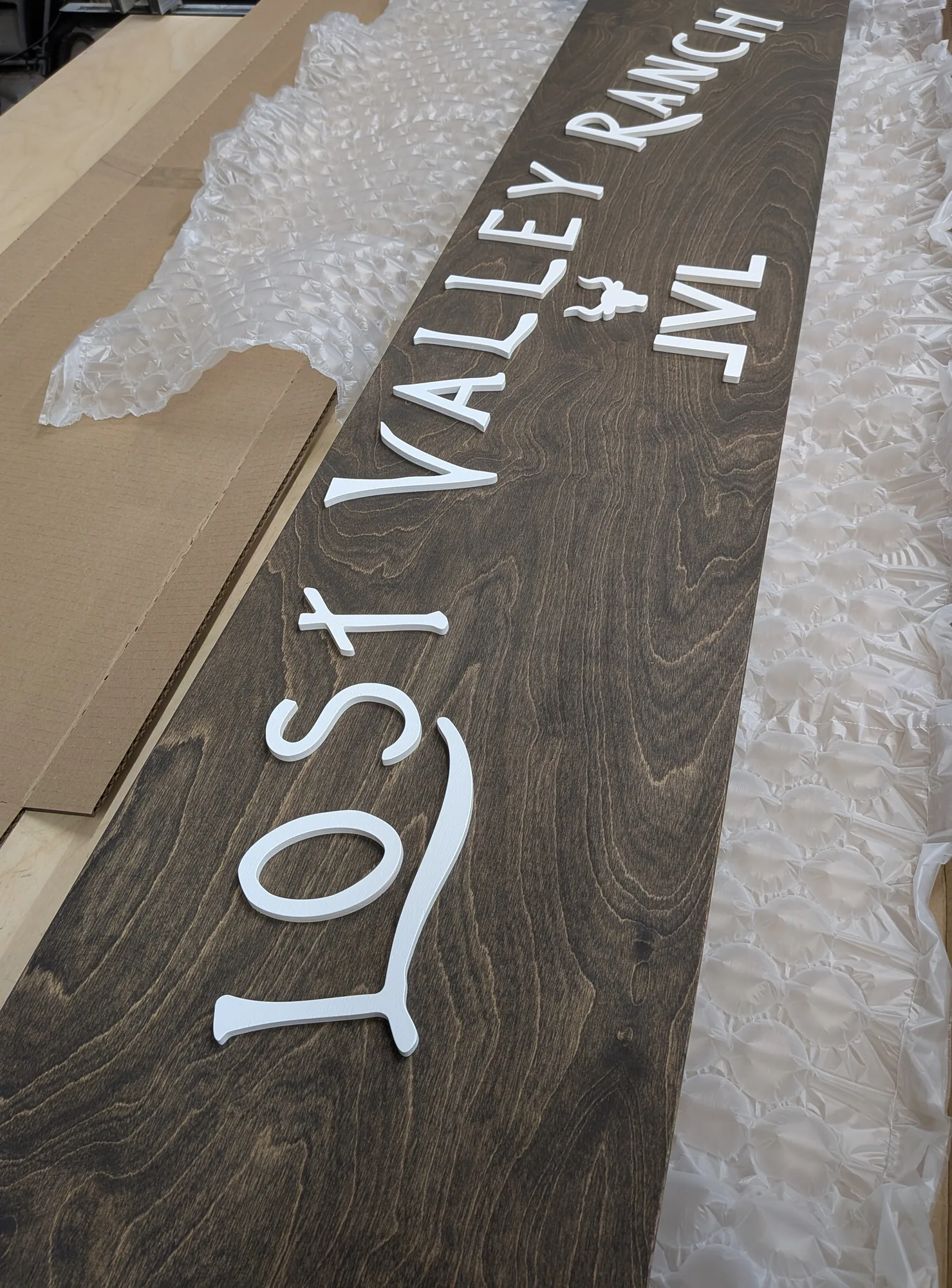 Aged walnut custom ranch sign recreating a destroyed original
