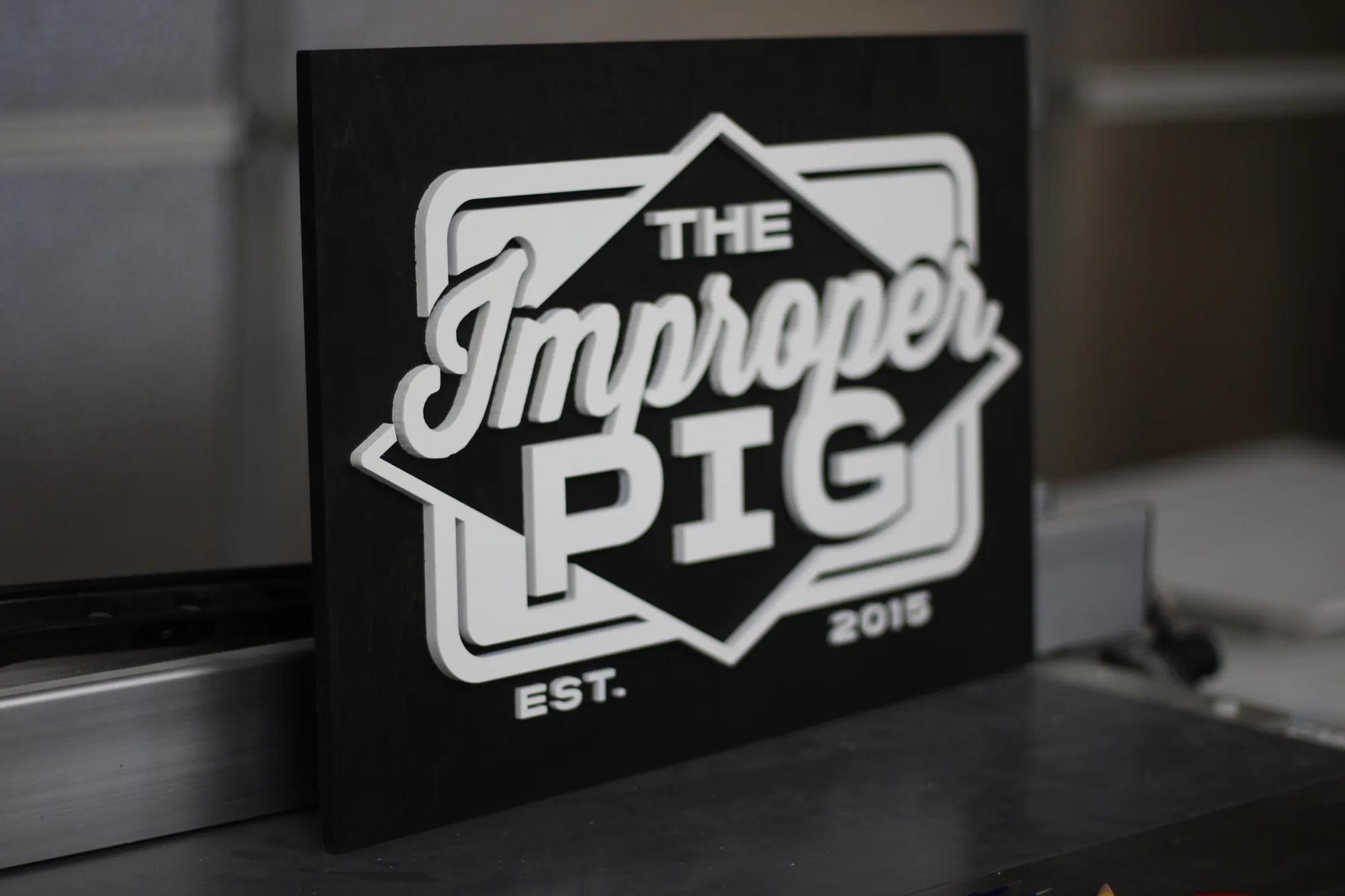 Ebony custom restaurant sign with white lettering for a BBQ restaurant