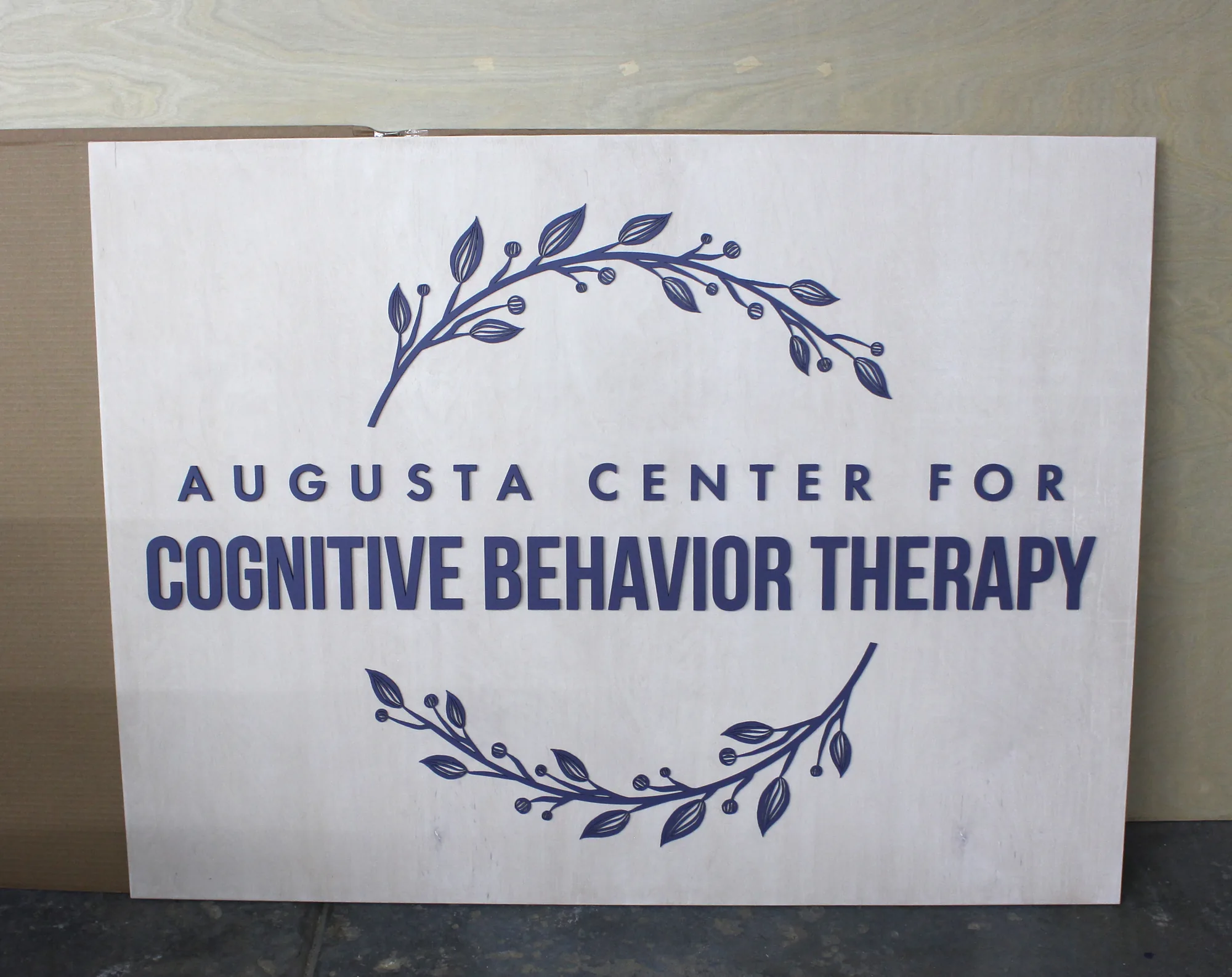 White wash therapy office sign with a purple logo