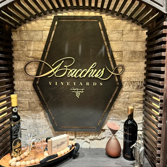 Ebony stained vineyard sign with a metallic gold logo