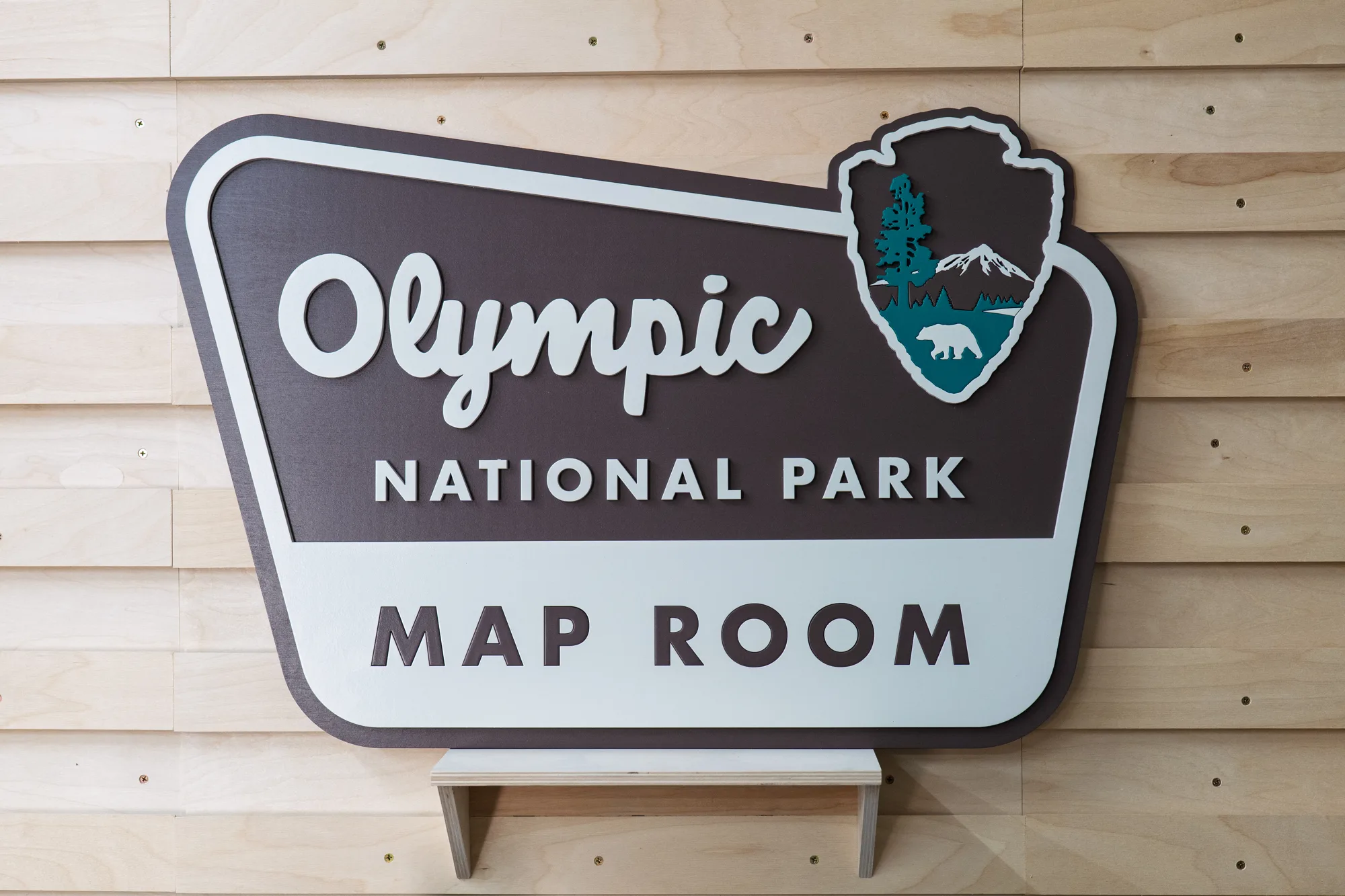 Painted national park style map room sign in brown, cream and teal