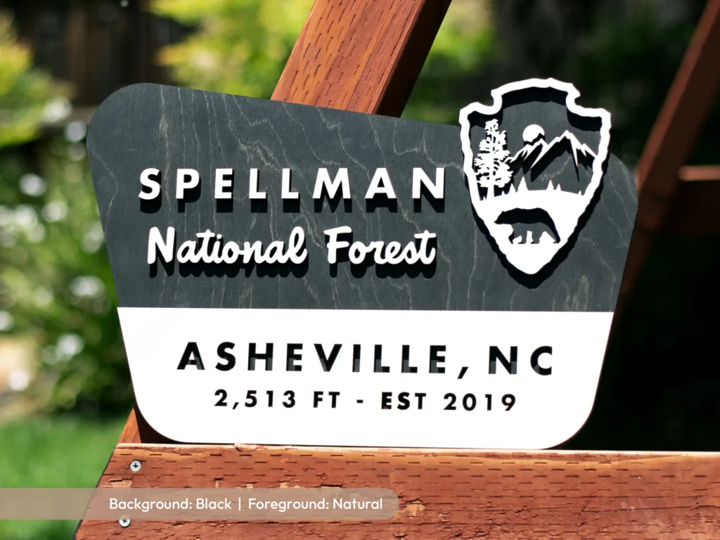 National forest style sign with a family name, town and elevation