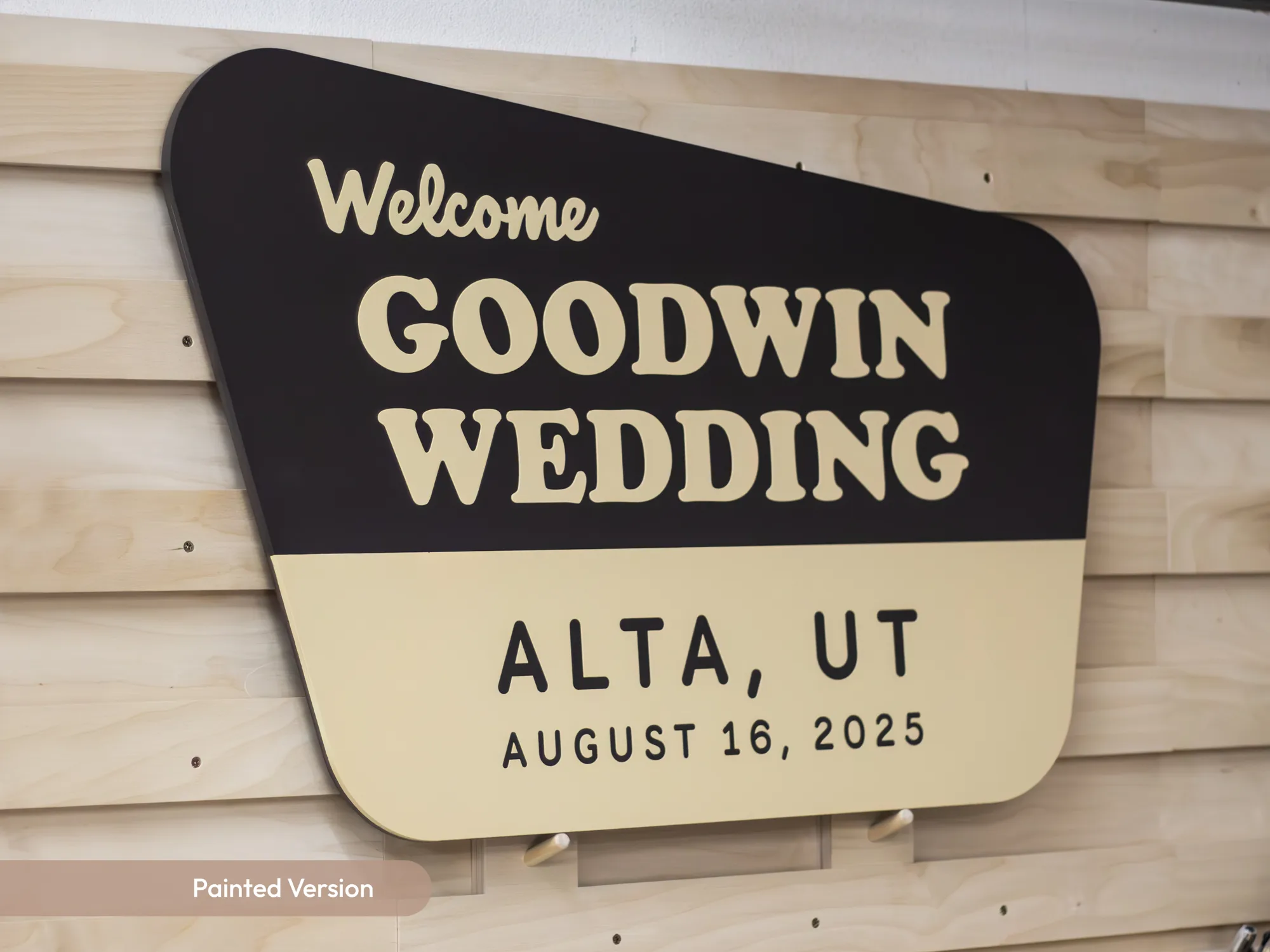 Painted national park style wedding sign with the couple's name, venue town and date