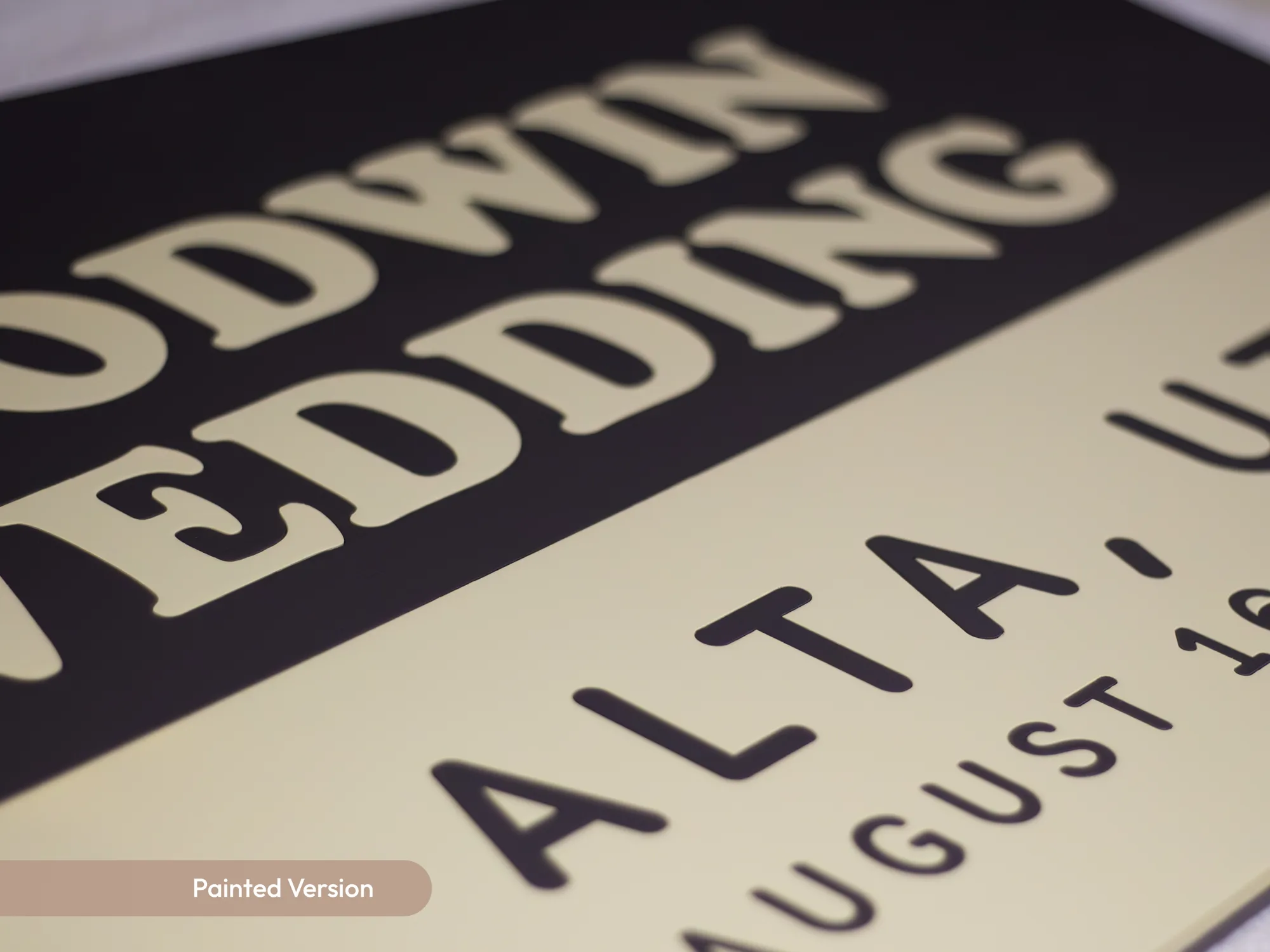 Close-up of raised painted lettering on the wedding sign